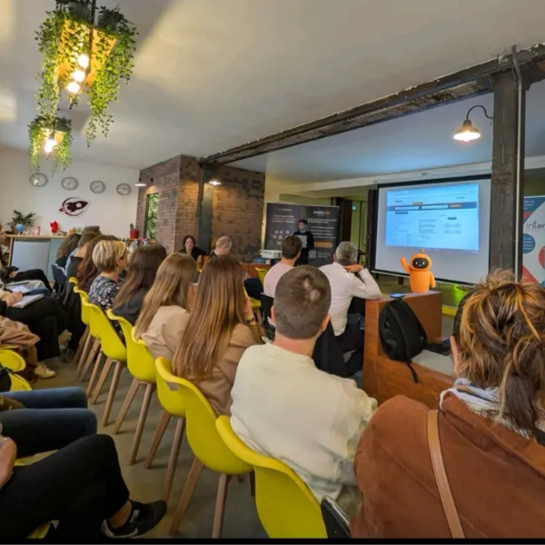 Salle avec des personnes assisent en face d'une présentation